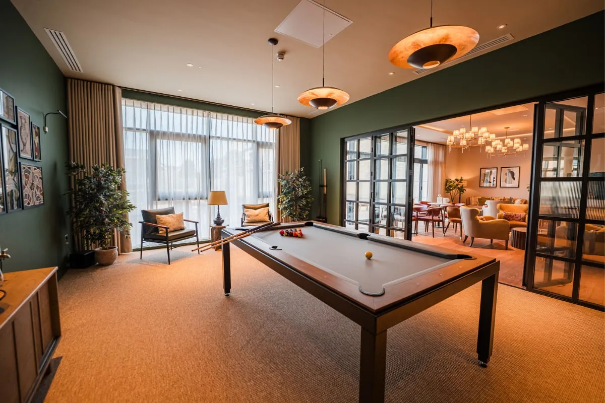 The games room at Strawberry Fields, with a pool table, opening onto the lounge
