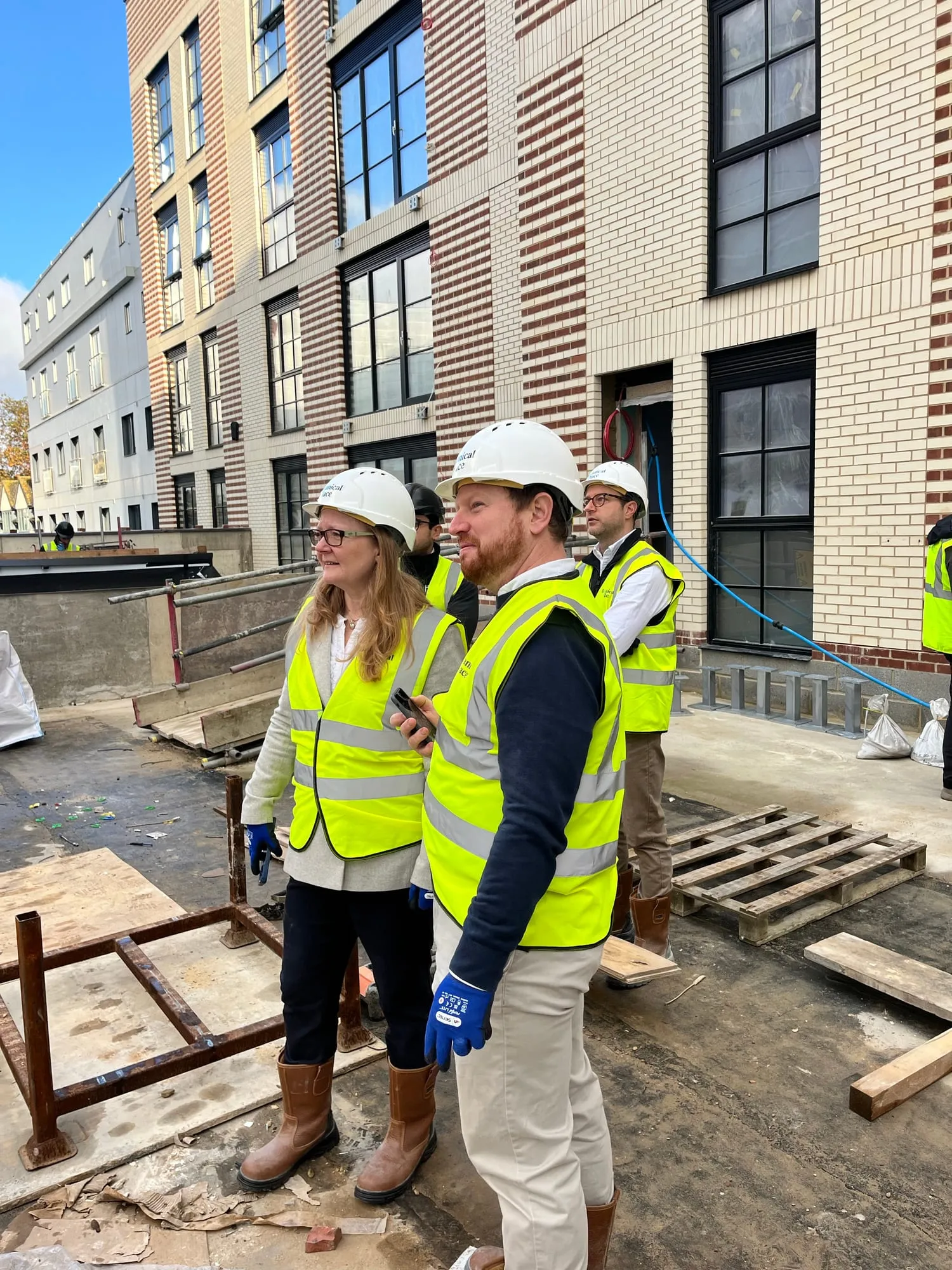 A site visit in hard hats and high-vis