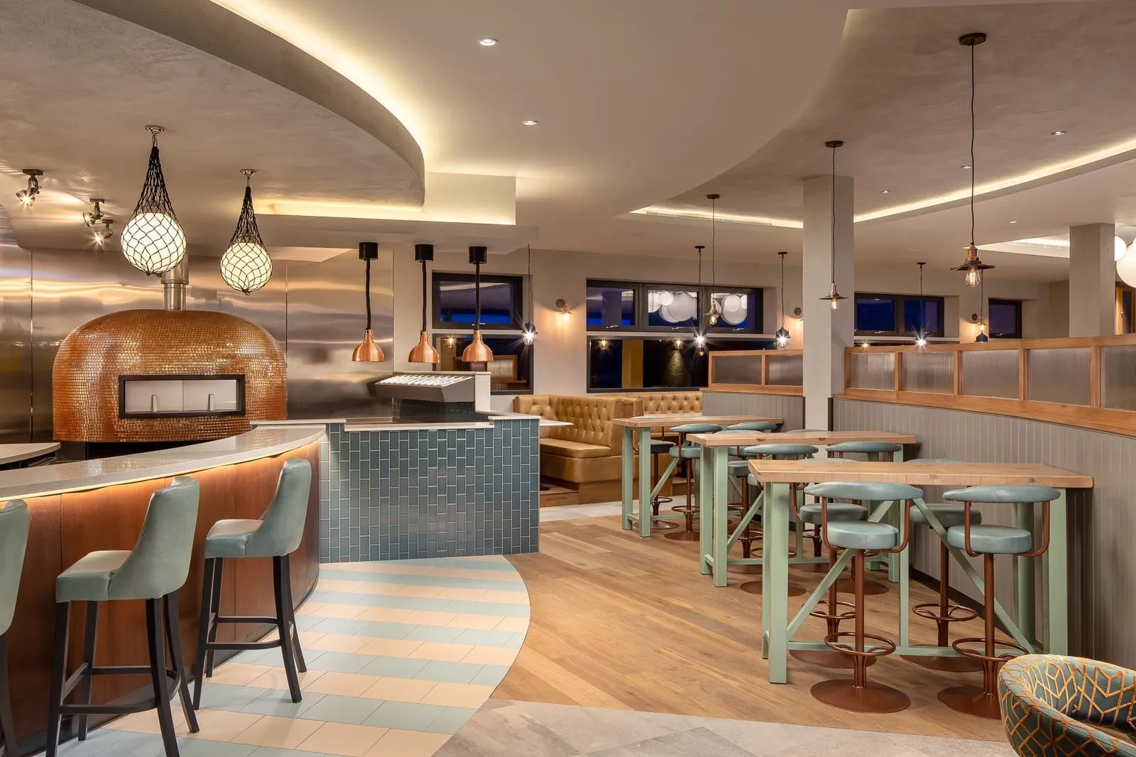 The restaurant at Milk Wood House, with a wood-fired oven, bar and open kitchen