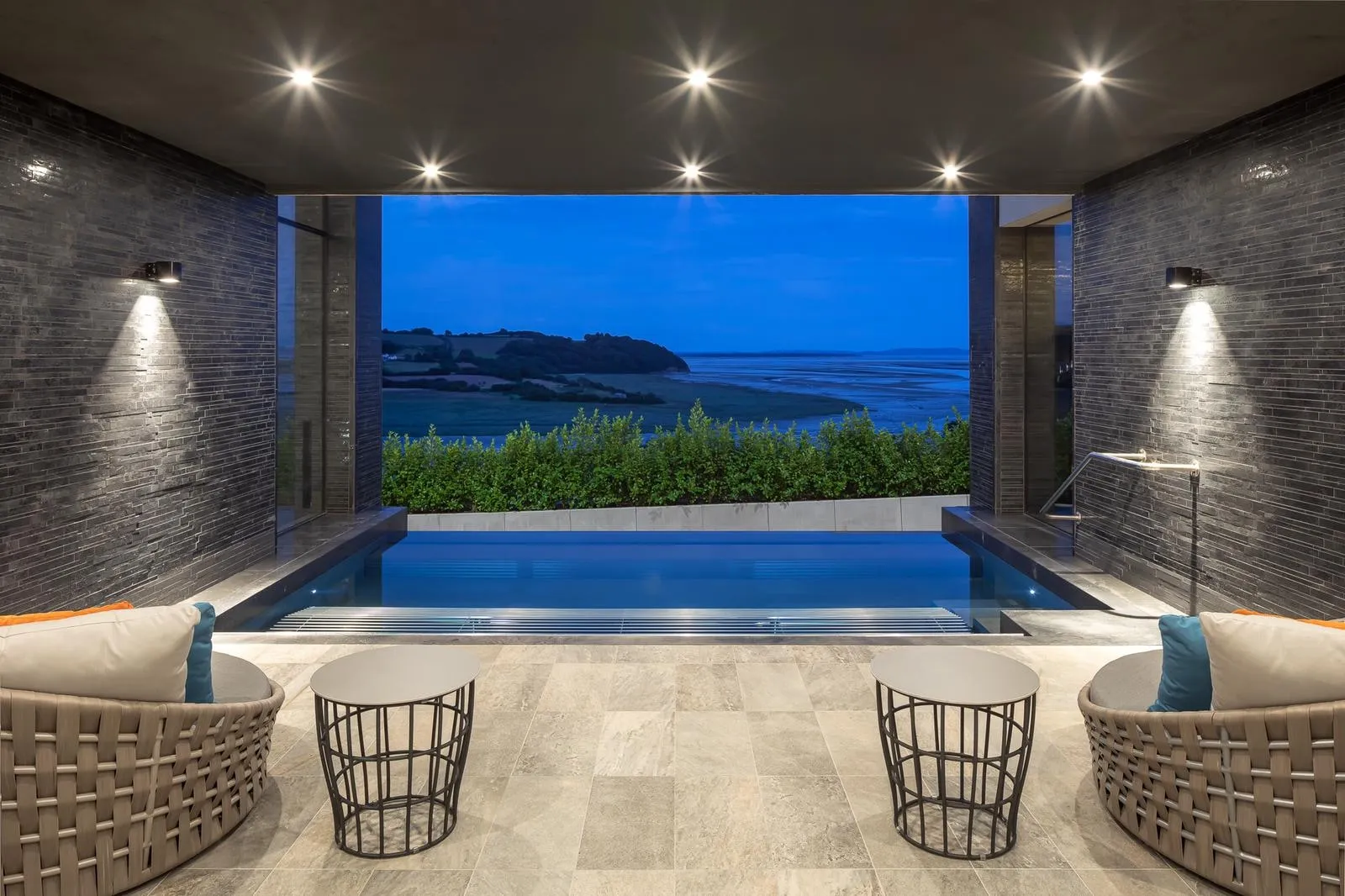 The pool at Milk Wood House, looking out over the Laugharne estuary at dusk