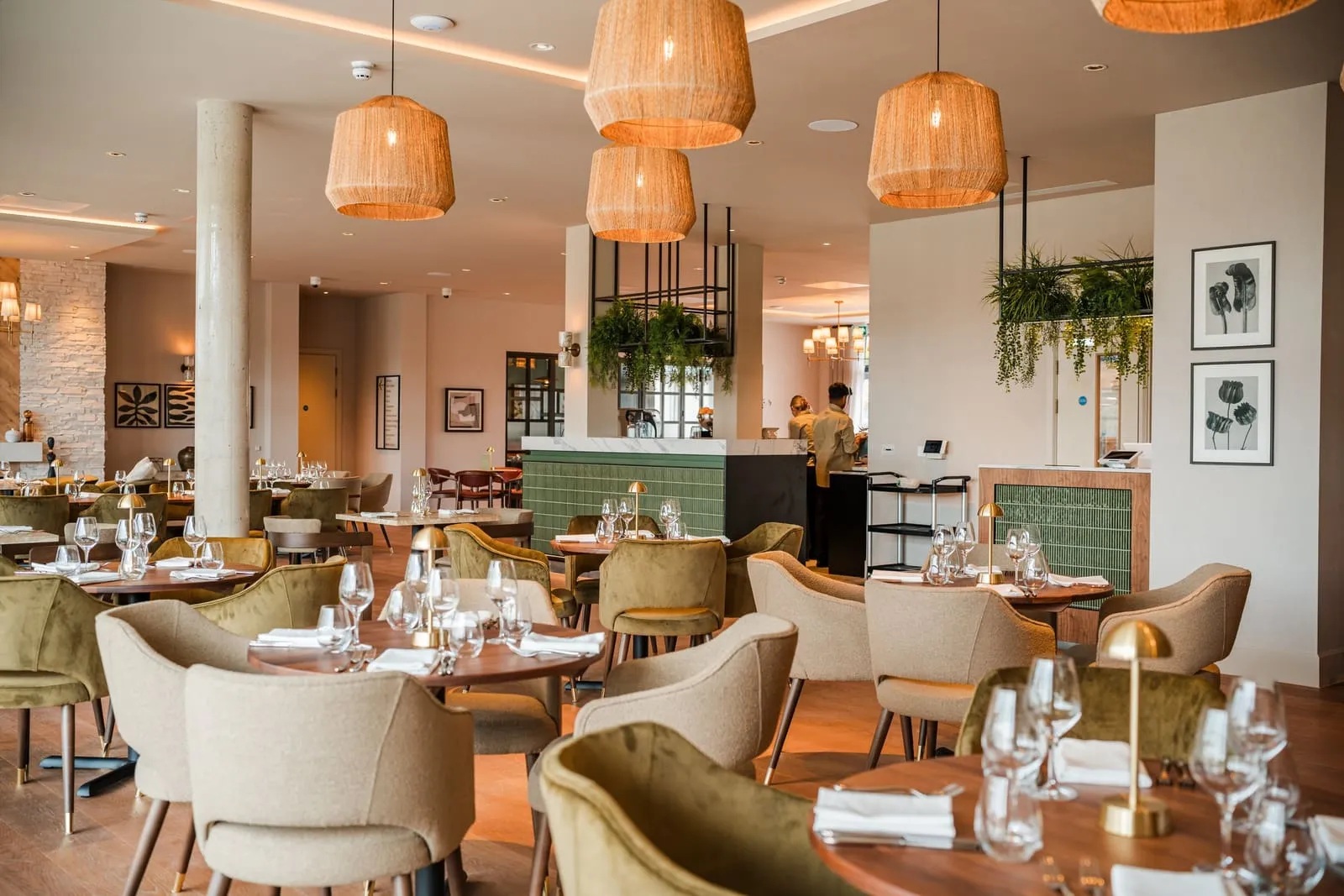 The restaurant at Strawberry Fields, with warm lighting, woven pendant lamps and timber furniture