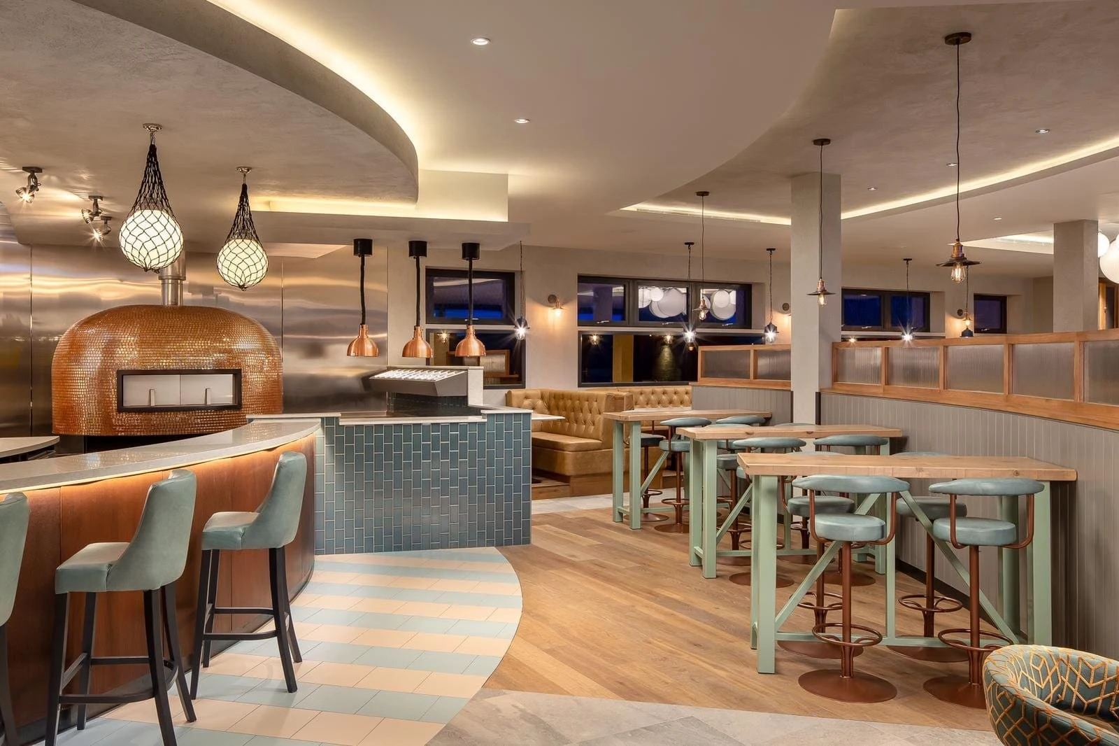Bar and dining area with a pizza oven at Milk Wood House