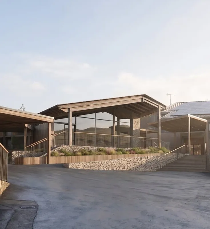 The new reception pavilion seen from the entrance courtyard, with its stone-clad terrace and steps
